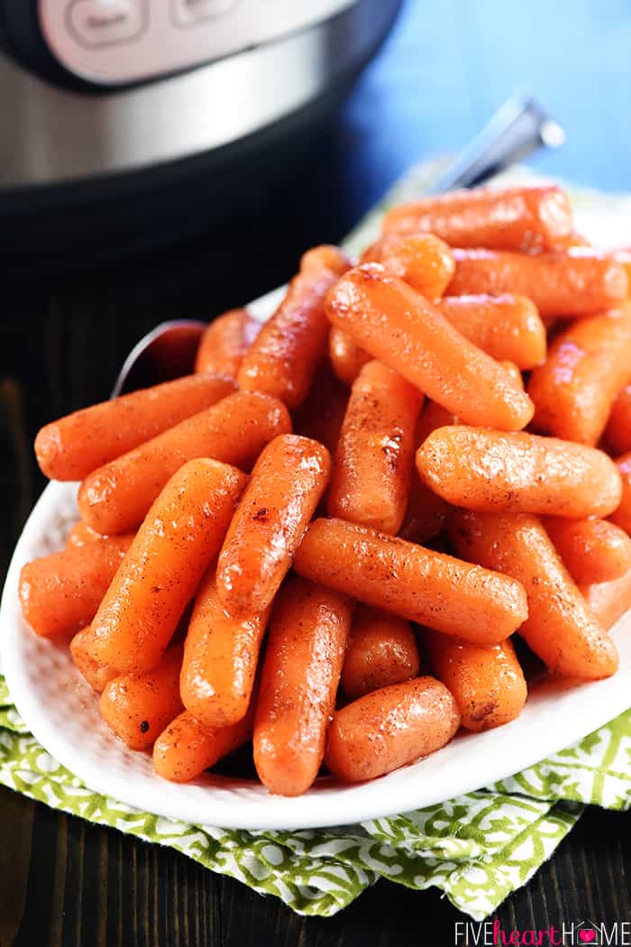 Instant Pot Carrots with spoon on white serving platter.