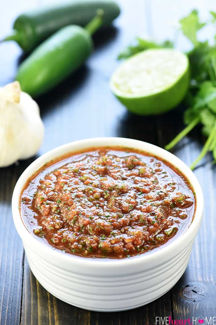 Canned Tomato Salsa in white bowl with ingredients in background.