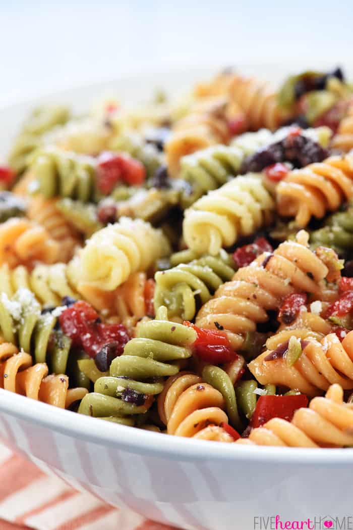 Close-up of pasta, olives, pimentos, parmesan, and Italian dressing.