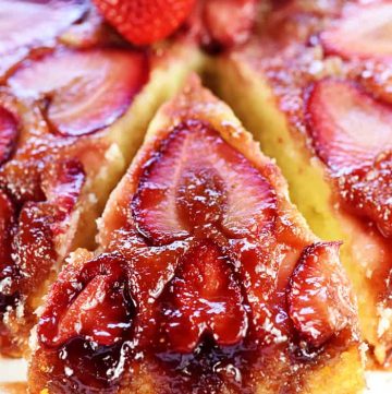 Strawberry Upside-Down Cake with slice being removed.