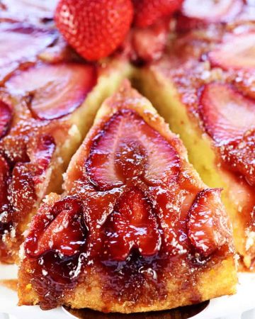 Strawberry Upside-Down Cake with slice being removed.