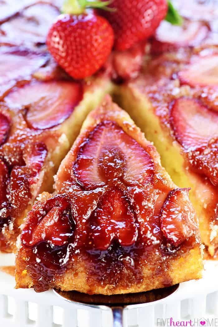 Strawberry Upside-Down Cake with slice being removed.