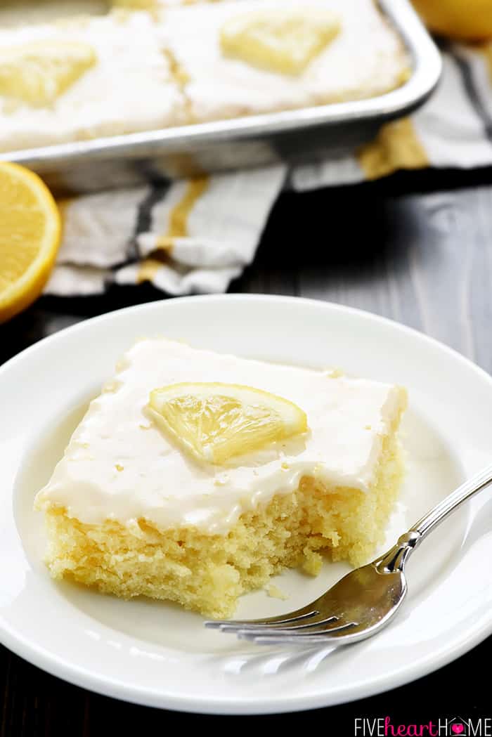 Slice of Lemon Sheet Cake on a plate with missing bite.