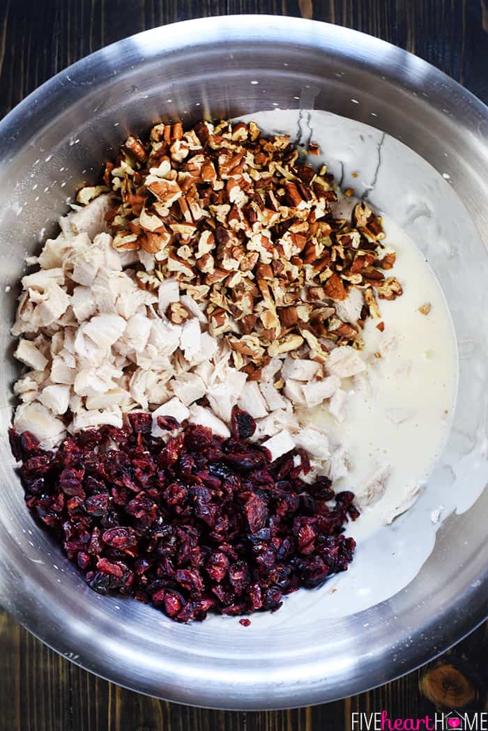 Sonoma Chicken Salad ~ studded with toasted pecans and dried cranberries in a lightened-up dressing including Greek yogurt & honey, this recipe makes scrumptious sandwiches for lunch, dinner, picnics, parties, or bridal and baby showers! | Five Heart Home.com Aerial view of ingredients in bowl.