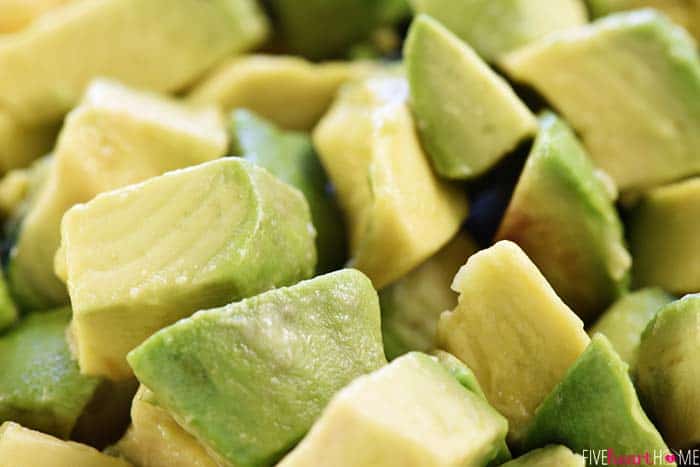 Cobb Pasta Salad ~ loaded with bacon, avocado, tomatoes, hard-boiled eggs, cheese, and homemade ranch dressing, this is the perfect recipe for summer picnics, potlucks, parties, and barbecues! | FiveHeartHome.com Close-up of diced avocado.