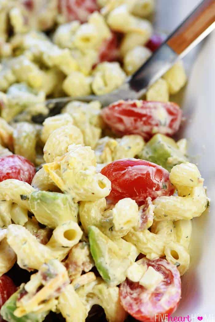 Cobb Pasta Salad Recipe ~ loaded with bacon, avocado, tomatoes, hard-boiled eggs, cheese, and homemade ranch dressing, this is the perfect pasta salad for summer picnics, potlucks, parties, and barbecues! | FiveHeartHome.com Cobb Pasta Salad recipe in bowl with spoon.