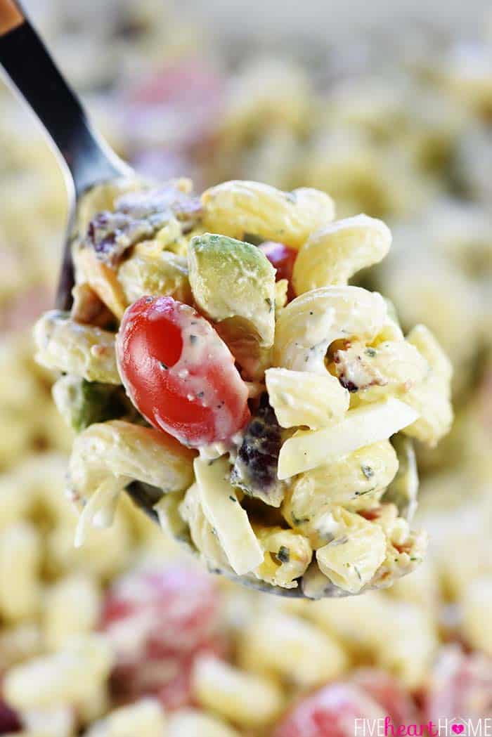 Cobb Pasta Salad ~ loaded with bacon, avocado, tomatoes, hard-boiled eggs, cheese, and homemade ranch dressing, this is the perfect recipe for summer picnics, potlucks, parties, and barbecues! | FiveHeartHome.com Big spoonful of Cobb Pasta Salad.