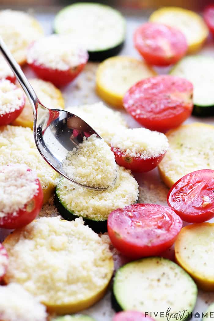 Spoon sprinkling grated parmesan.