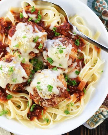 Chicken Parmesan Meatballs ~ a ground chicken mixture is formed into meatballs, rolled in Panko and Parmesan, baked, and then covered in flavorful marinara sauce and melted mozzarella...perfect for servings as an appetizer, over pasta, or on subs! | FiveHeartHome.com