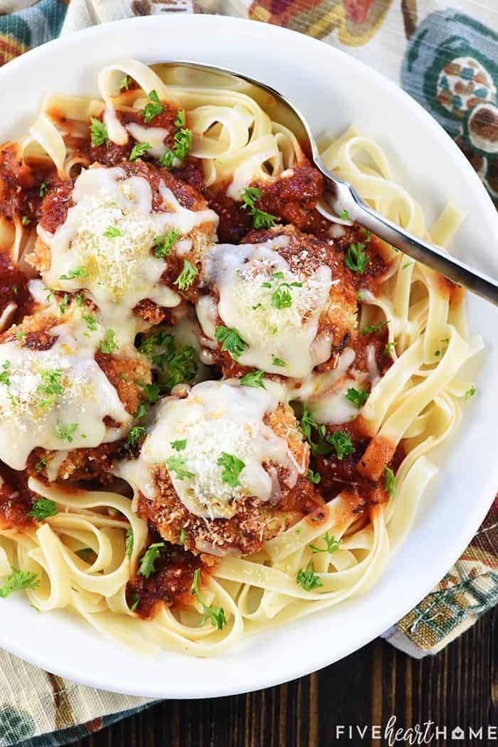 Chicken Parmesan Meatballs ~ a ground chicken mixture is formed into meatballs, rolled in Panko and Parmesan, baked, and then covered in flavorful marinara sauce and melted mozzarella...perfect for servings as an appetizer, over pasta, or on subs! | FiveHeartHome.com