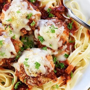 Chicken Parmesan Meatballs ~ a ground chicken mixture is formed into meatballs, rolled in Panko and Parmesan, baked, and then covered in flavorful marinara sauce and melted mozzarella...perfect for servings as an appetizer, over pasta, or on subs! | FiveHeartHome.com