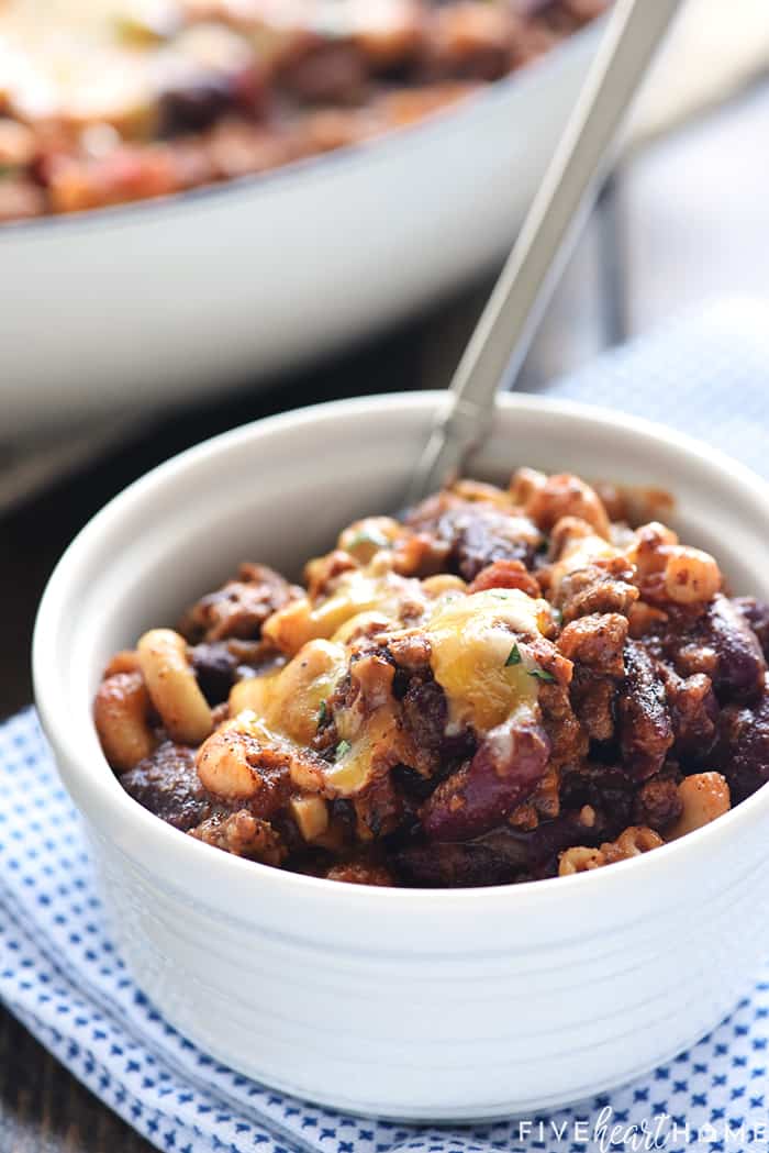 Bowl filled to the brim with spoon sticking out.