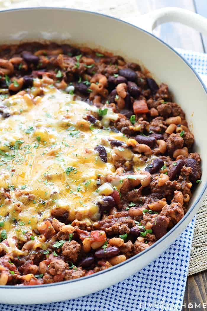 Skillet of Chili Mac garnished with parlsey.