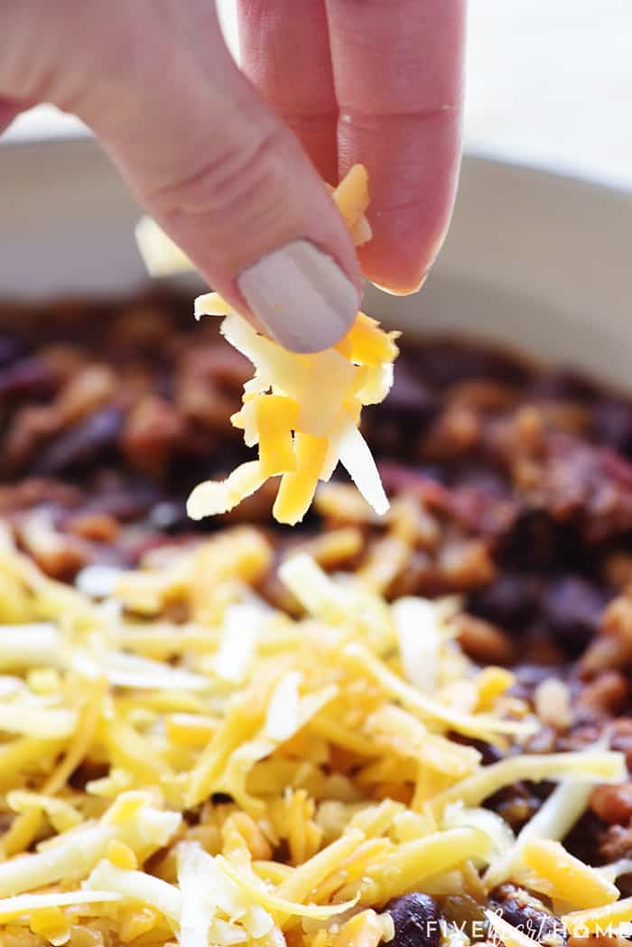 Sprinkling grated cheese on top.