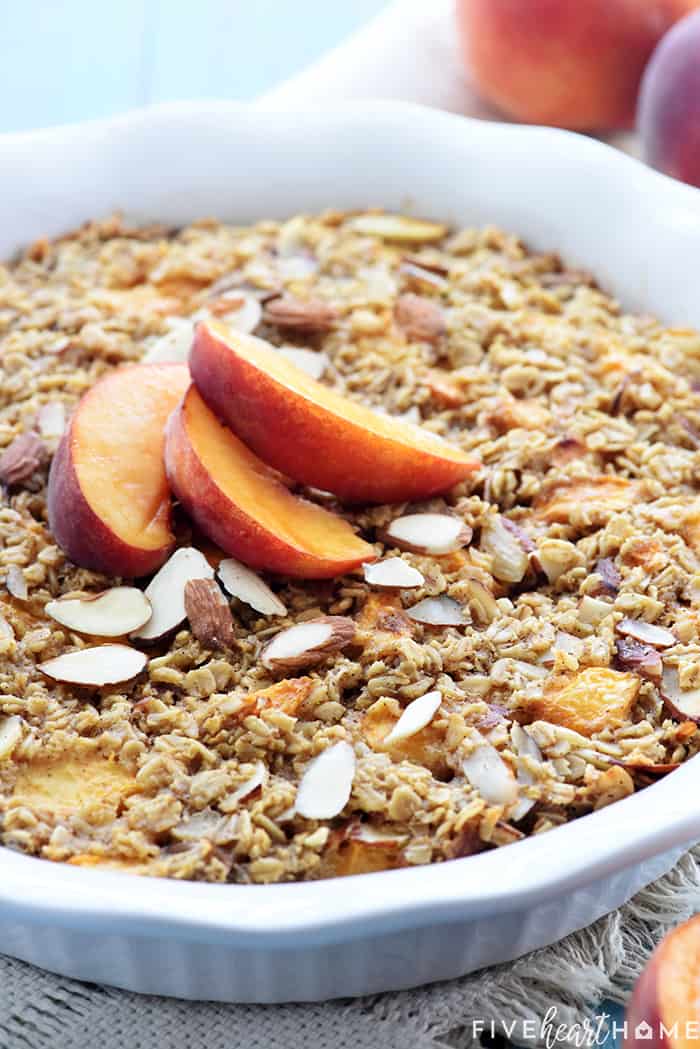 Peach Baked Oatmeal in baking dish with sliced peaches on top.