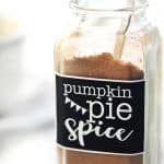 Pumpkin Pie Spice in a labeled spice bottle with measuring spoon