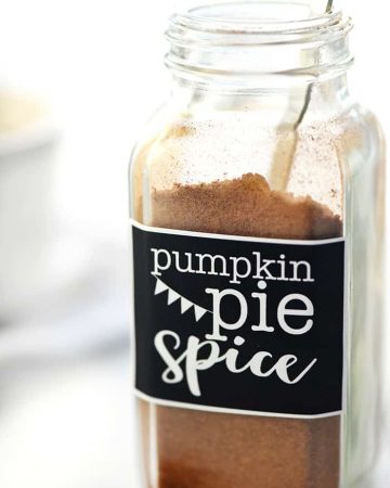 Pumpkin Pie Spice in a labeled spice bottle with measuring spoon