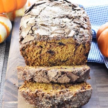 Sliced Snickerdoodle Pumpkin Bread on a cutting board