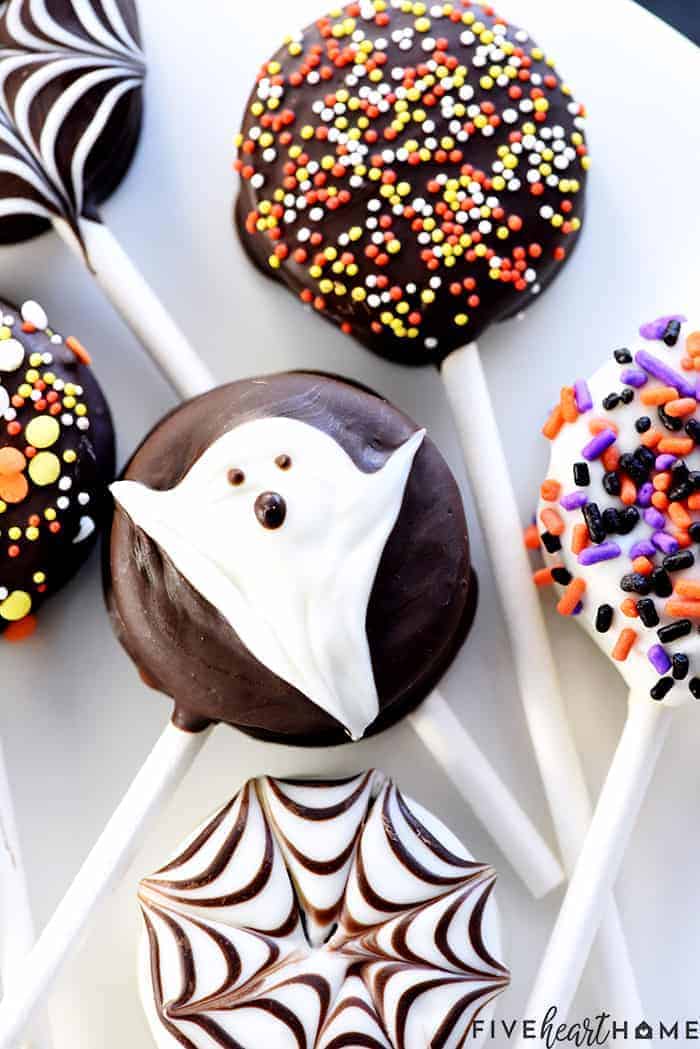 Halloween Oreo Pops decorated as a Ghost, with sprinkles, and with spiderwebs