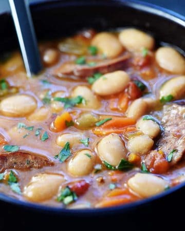 Slow Cooker Cajun White Bean Soup ~ a cozy crock pot recipe loaded with beans, andouille sausage, veggies, and a flavorful broth that's sure to warm you up! | FiveHeartHome.com