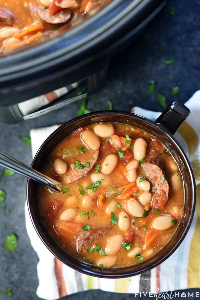 Aerial view of Cajun white bean soup in bowl and crockpot.