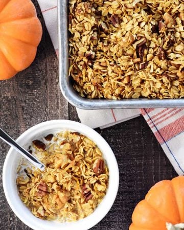 Healthy Pumpkin Granola ~ crunchy, golden, and easy to make, loaded with wholesome oats, toasty nuts, real pumpkin puree, coconut oil, maple syrup, & warm fall spices! | FiveHeartHome.com