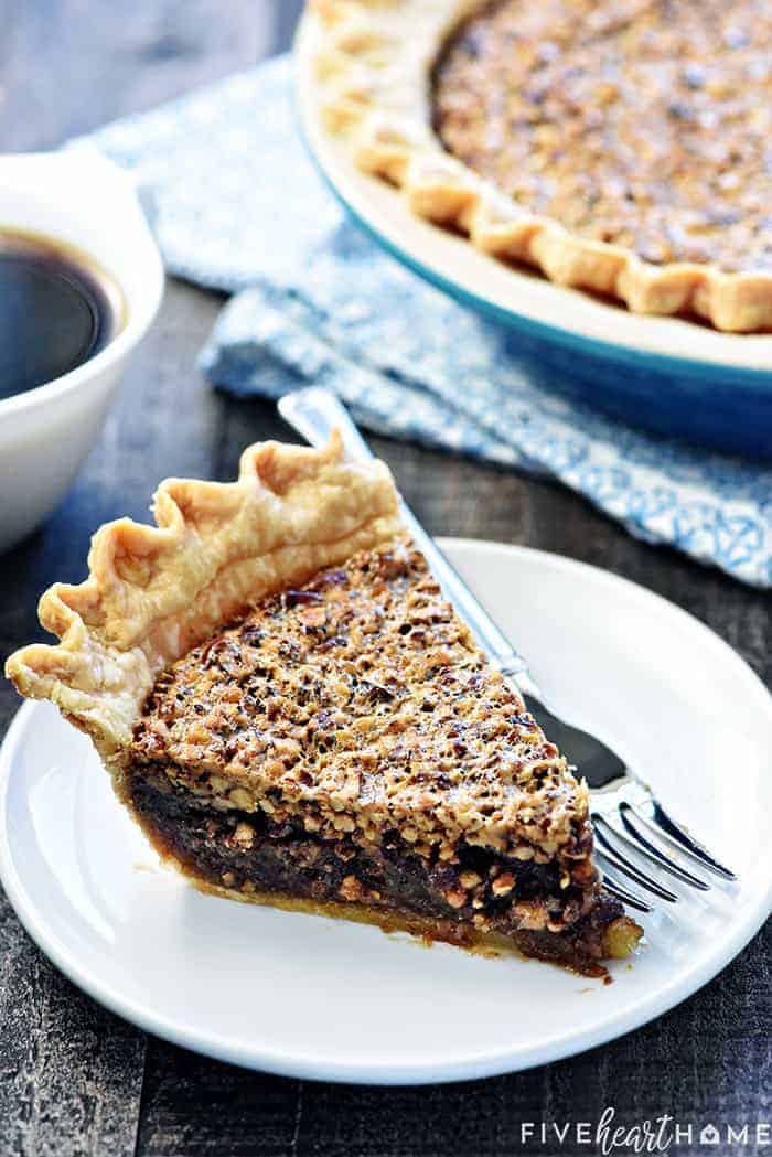 The BEST Pecan Pie ~ foolproof and perfect every time, with an abundance of toasty pecans floating on a thick, glossy filling in a flaky, all-butter pie crust! | FiveHeartHome.com Best Pecan Pie recipe served with coffee.