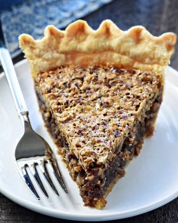 The BEST Pecan Pie ~ foolproof and perfect every time, with an abundance of toasty pecans floating on a thick, glossy filling in a flaky, all-butter pie crust! | FiveHeartHome.com