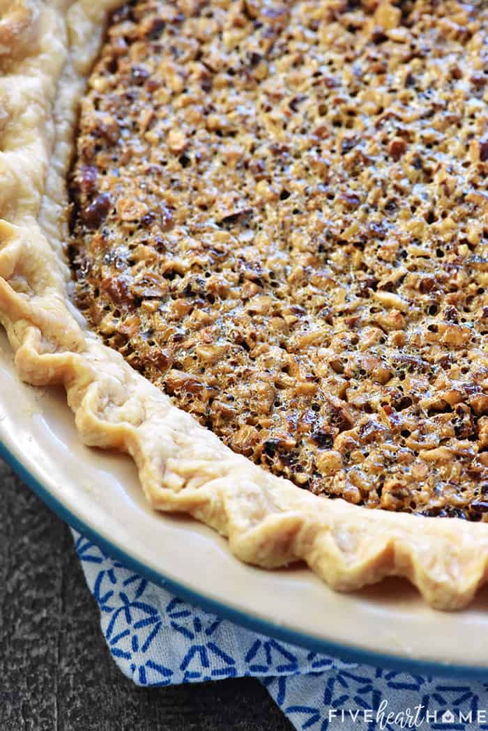 The BEST Pecan Pie ~ foolproof and perfect every time, with an abundance of toasty pecans floating on a thick, glossy filling in a flaky, all-butter pie crust! | FiveHeartHome.com Close-up of surface of pie.