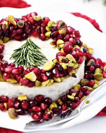 Christmas Brie ~ a simple, red-green-and-white holiday appetizer featuring Brie, pomegranate, and pistachios, garnished with a festive rosemary Christmas tree! | FiveHeartHome.com