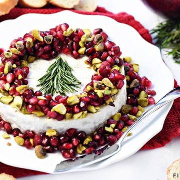 Christmas Brie ~ a simple, red-green-and-white holiday appetizer featuring Brie, pomegranate, and pistachios, garnished with a festive rosemary Christmas tree! | FiveHeartHome.com