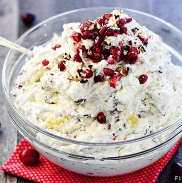 Cranberry Pomegranate Fluff Salad ~ a new twist on the classic recipe, loaded with tart cranberries, sweet pomegranate arils, crushed pineapple, toasty pecans, chewy coconut, fluffy marshmallows, and fresh whipped cream for a delicious holiday side dish! | FiveHeartHome.com