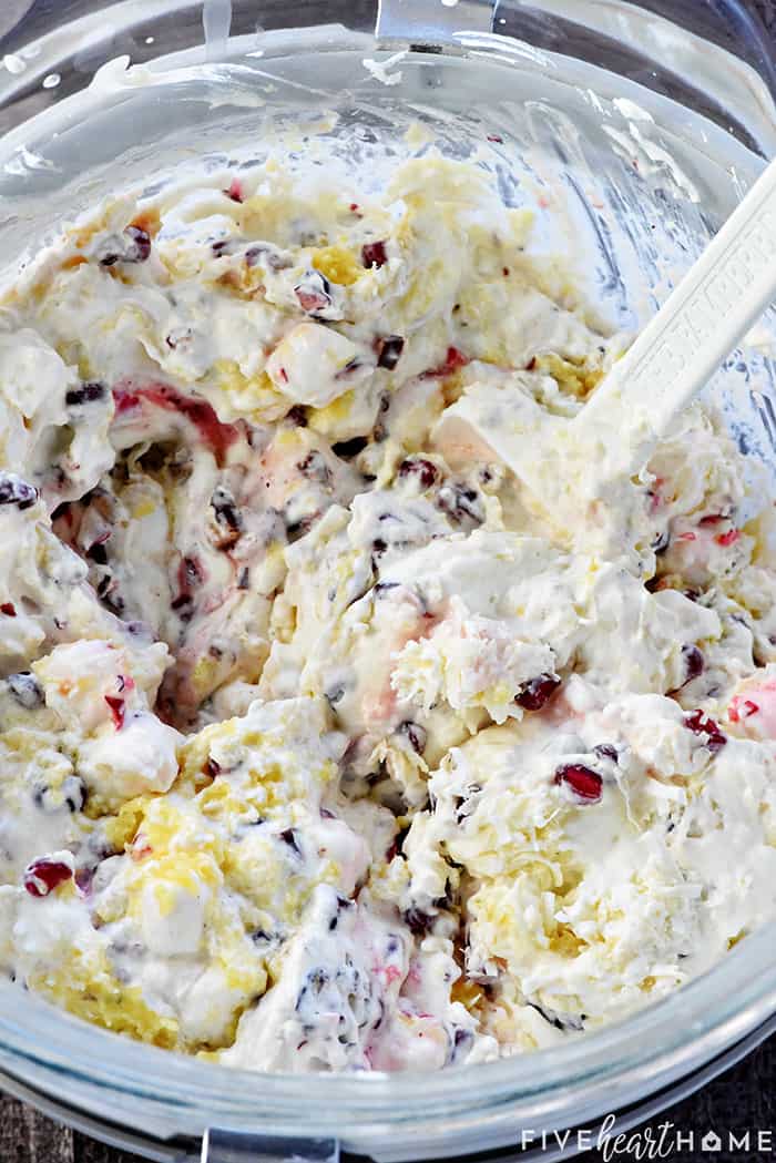 Ingredients being mixed together in glass bowl.