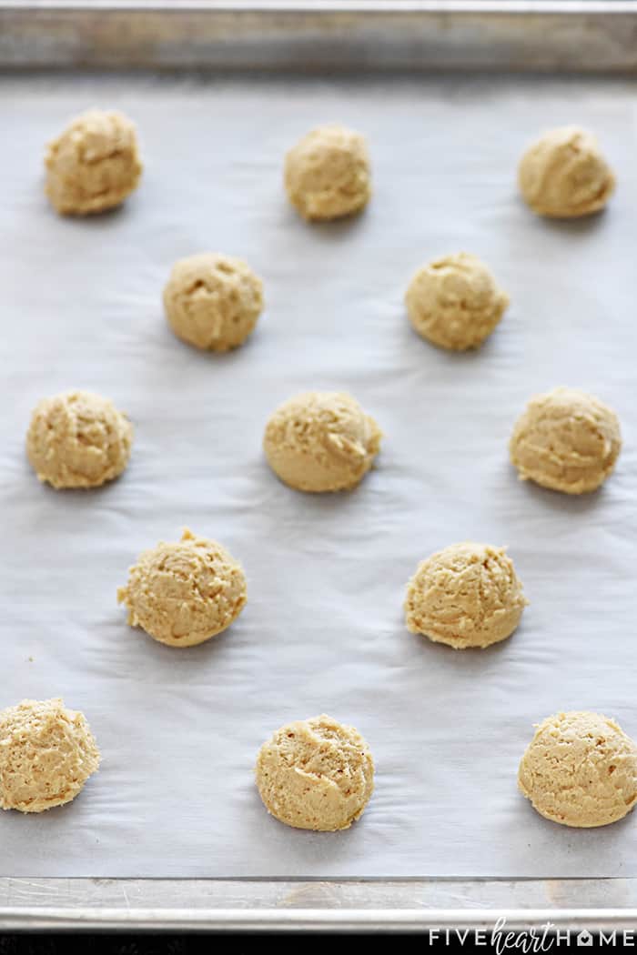Cookie sheet with balls of dough ready to go into oven.