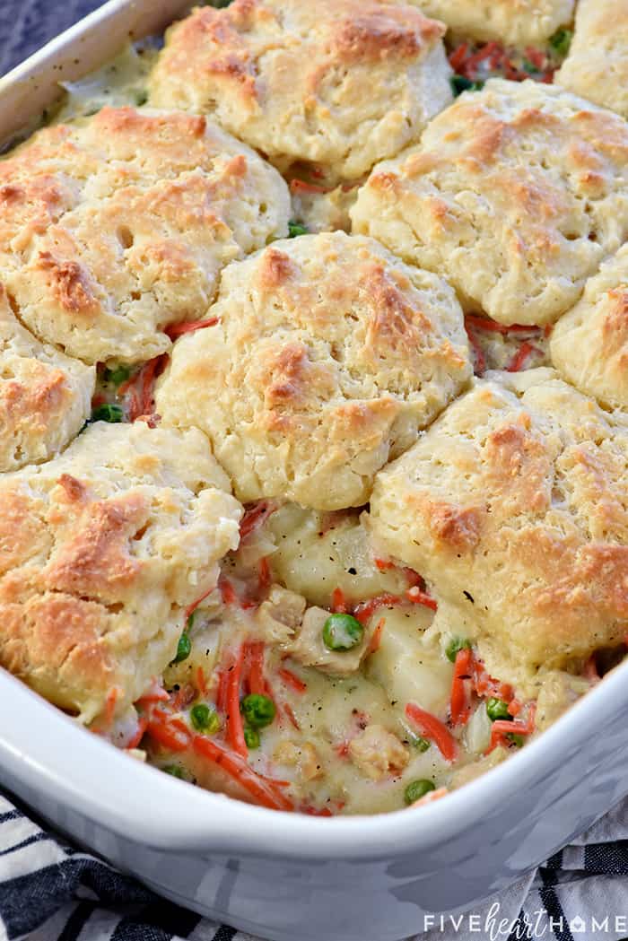 Chicken Pot Pie Casserole ~ this easy comfort food recipe features a classic filling of tender chicken, potatoes, carrots, and peas in a savory gravy topped with fluffy homemade drop biscuits! | FiveHeartHome.com Chicken Pot Pie Casserole in baking dish with missing scoop.