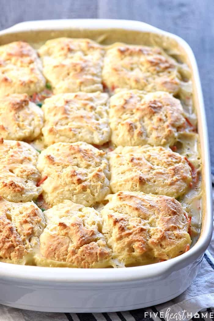 Chicken Pot Pie Casserole in baking dish with biscuits on top.