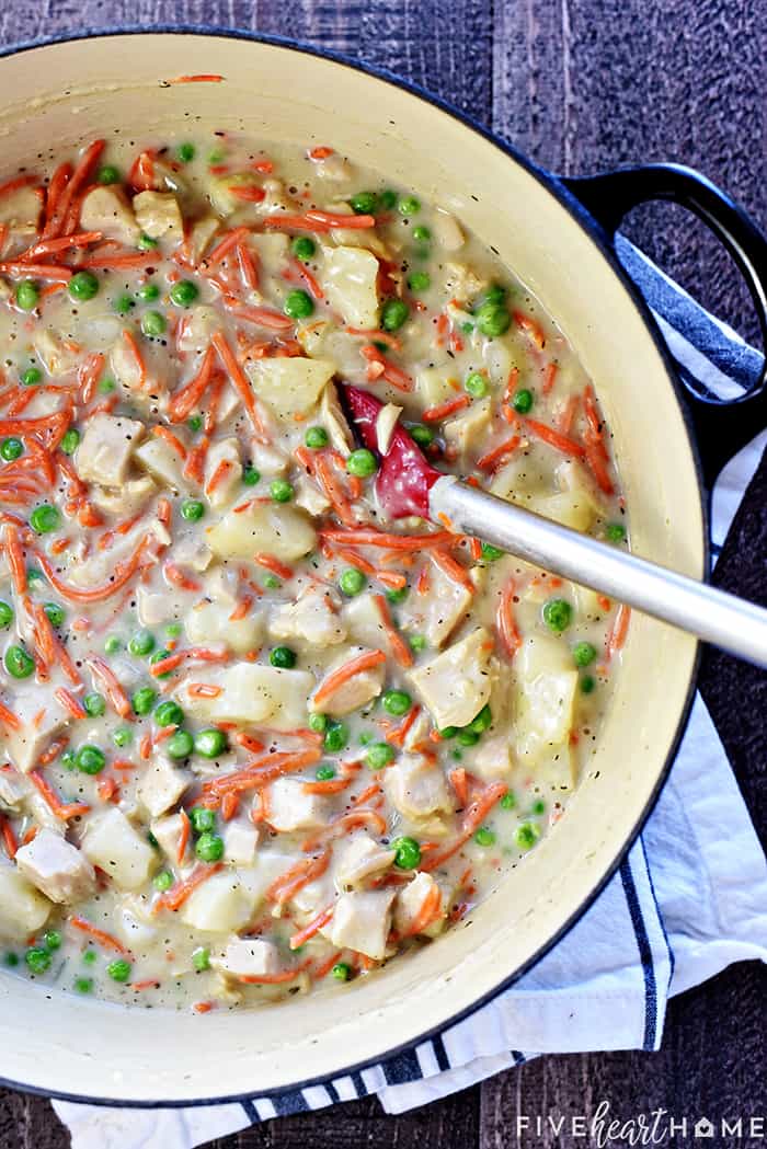 Chicken Pot Pie Casserole ~ this easy comfort food recipe features a classic filling of tender chicken, potatoes, carrots, and peas in a savory gravy topped with fluffy homemade drop biscuits! | FiveHeartHome.com Stirring together the filling in a pot.