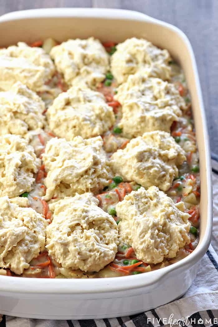 Chicken Pot Pie Casserole ~ this easy comfort food recipe features a classic filling of tender chicken, potatoes, carrots, and peas in a savory gravy topped with fluffy homemade drop biscuits! | FiveHeartHome.com Drop biscuits on top of Chicken Pot Pie Casserole, ready for the oven.
