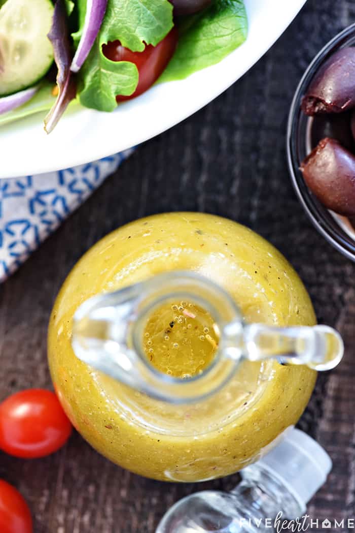 Aerial view of Greek Salad Dressing in cruet.