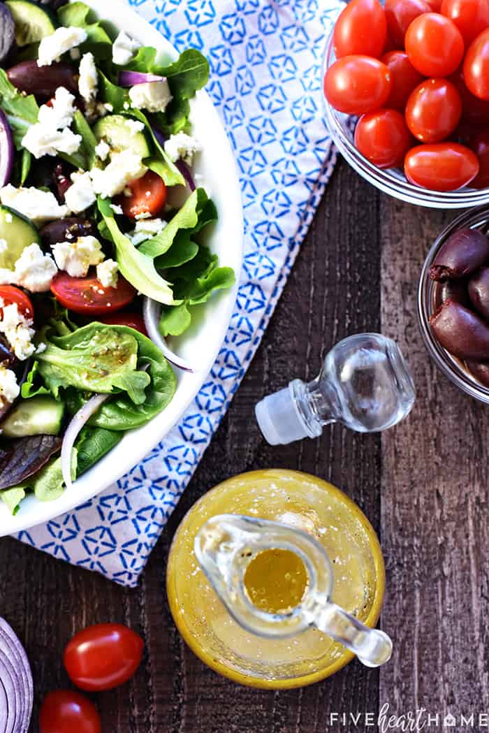 Aerial view of Greek dressing plus ingredients for salad.