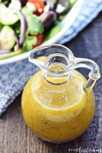 Homemade Greek Salad Dressing ~ tangy, easy to make, and delicious drizzled over a Greek salad with tomatoes, cucumbers, Kalamata olives, onions, and Feta! | FiveHeartHome.com
