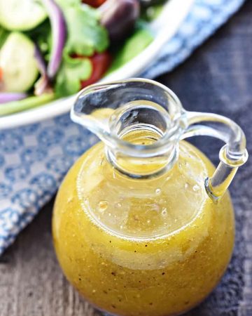Homemade Greek Salad Dressing ~ tangy, easy to make, and delicious drizzled over a Greek salad with tomatoes, cucumbers, Kalamata olives, onions, and Feta! | FiveHeartHome.com