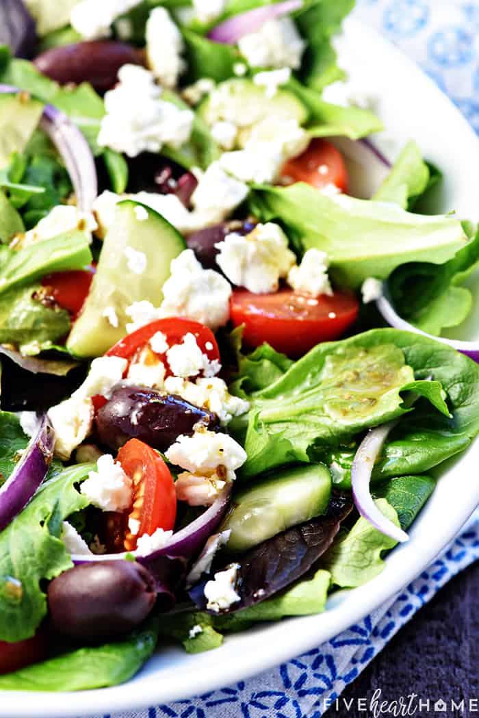 Close-up of salad drizzled with Greek dressing recipe.