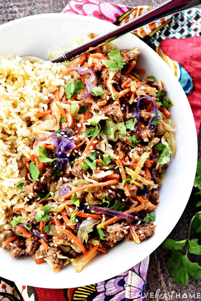 Aerial view of Instant Pot Egg Roll in a Bowl on plate with rice.