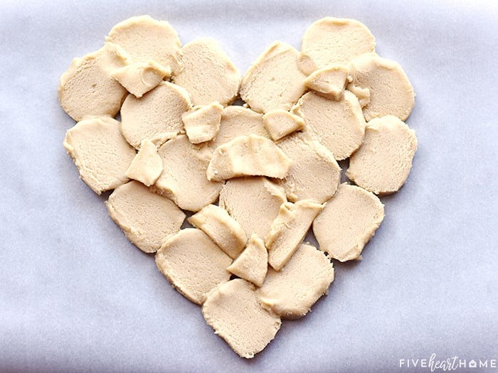 Sugar cookie dough slices arranged in shape of a heart.