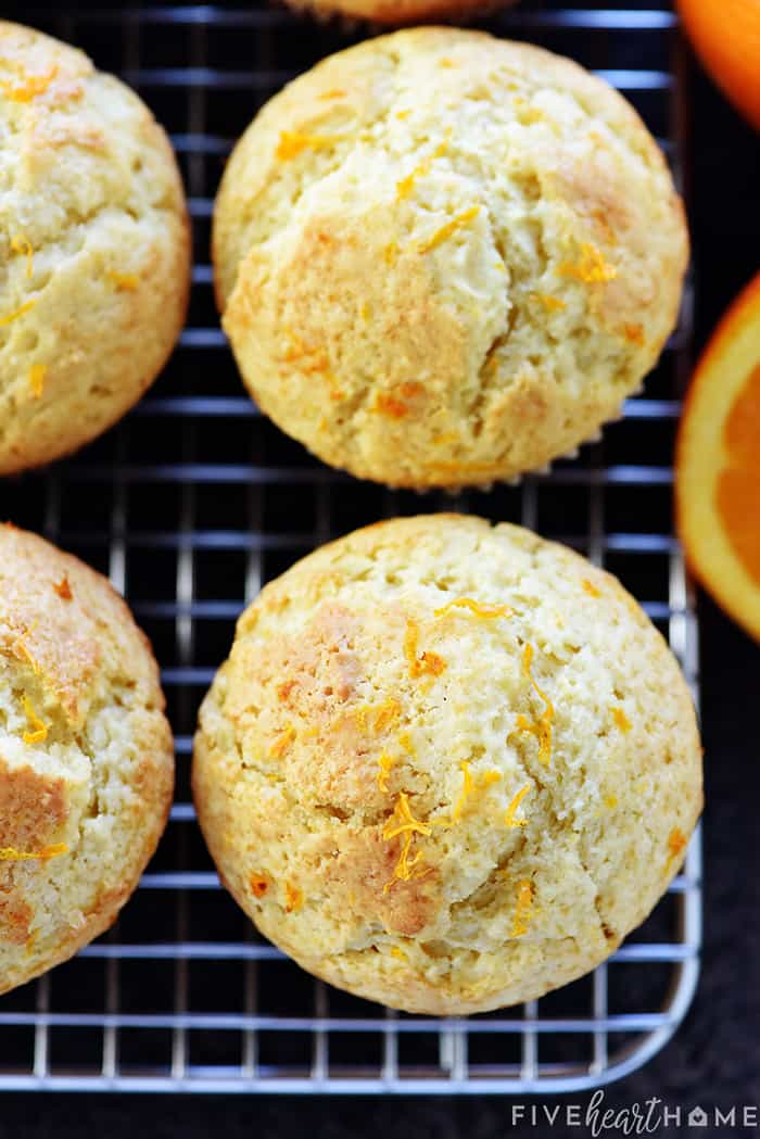 Orange Muffins ~ these lovely muffins are tender, and easy to make from scratch, with delicate flavors of vanilla and citrus from fresh orange juice and zest! | FiveHeartHome.com Aerial view of Orange Muffins sprinkled with fresh zest.
