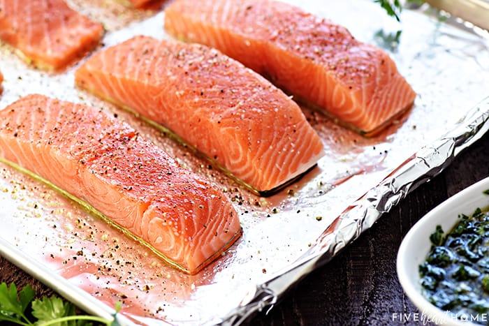 Raw, seasoned fillets on sheet pan.