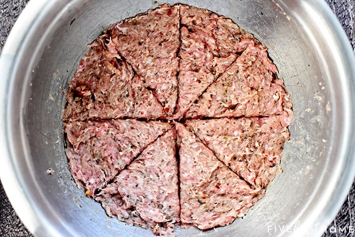 Meat mixture in a bowl, evenly divided into 16 triangles