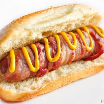 Bacon Wrapped Hot Dogs with Cheese ~ cooked on the grill, this recipe takes a summertime staple to the next level...it's sure to be a hit at any party or barbecue! | FiveHeartHome.com #hotdogs