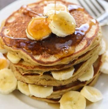 Perfect Whole Wheat Banana Pancakes ~ scrumptious and wholesome, these pancakes are light and fluffy with crisp, golden edges and delicious banana flavor. And nobody will ever guess that this amazing banana pancake recipe is made with 100% whole wheat flour! | FiveHeartHome.com
